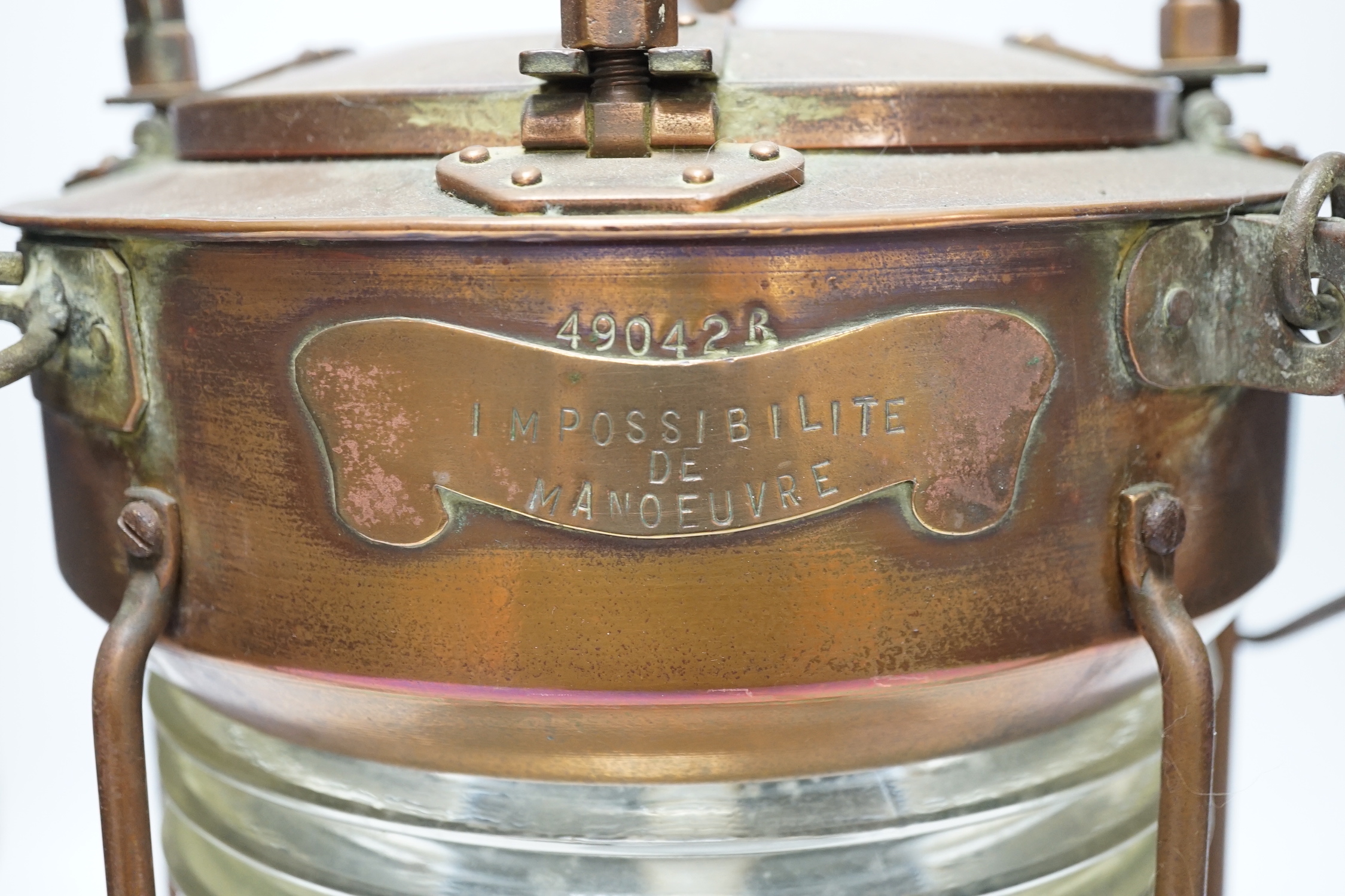 A copper ship’s lamp, with fresnel lens glass, 40cm high